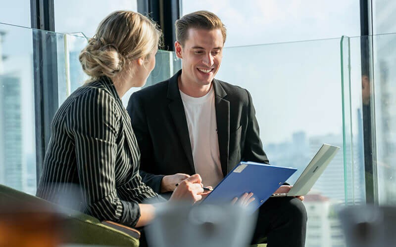 What is Microsoft NCE? Two colleagues talking to each other