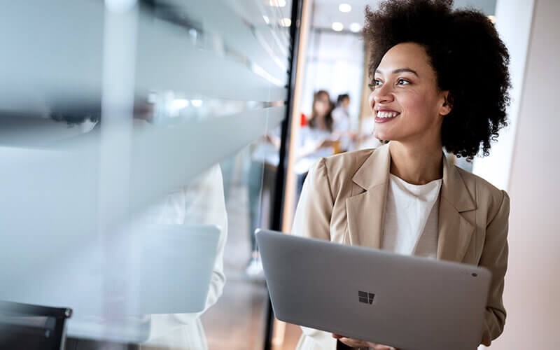 Managing your licenses through NCE is even easier with our Insight Cloud Care included in your subscription. Woman smiling using her laptop