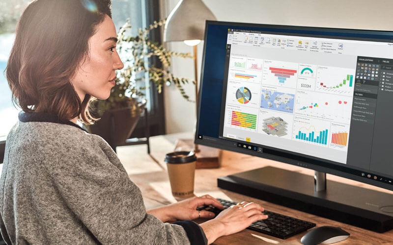Microsoft Power BI data on one dashboard Female working on Power BI platform