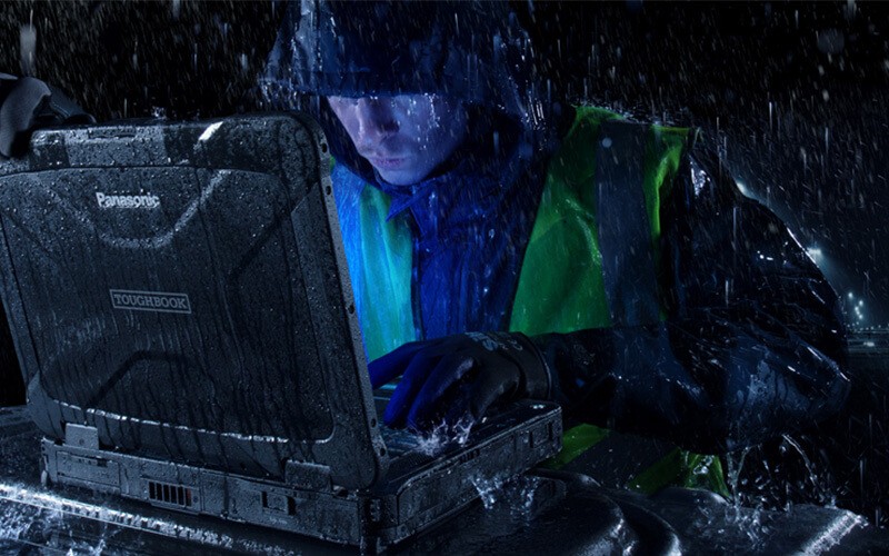 Panasonic public safety solutions Man using Toughbook while raining