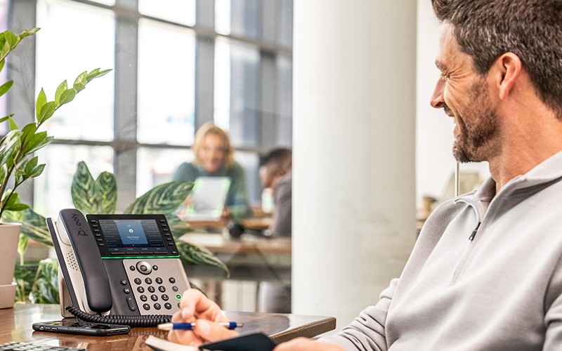 Polycom enterprise-grade, high definition voice solutions Business man using Polycom phone