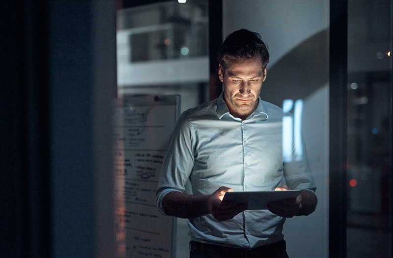 business-man-using-tablet-in-office-night business-man-using-tablet-in-office-night
