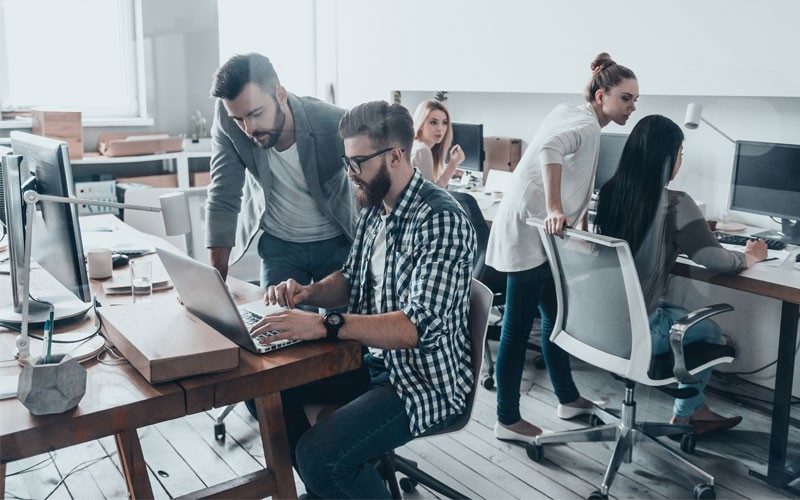 Protect your data on public or private clouds Various businessmen and women working in modern open office