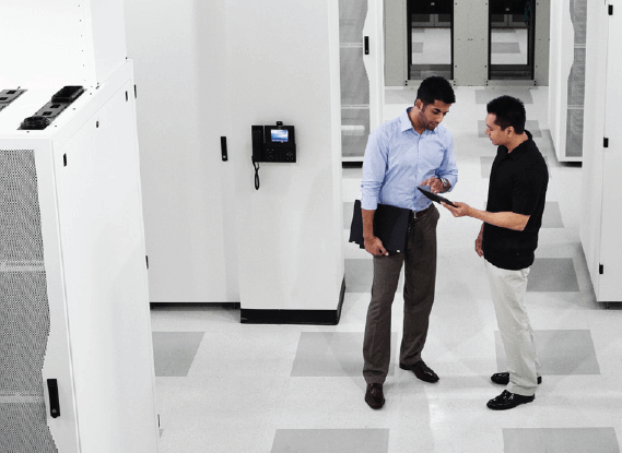 Resilio Connect reliable solution for scalability Two business men looking at tablet device in data center