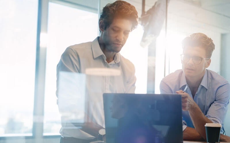 Rubrik automates data backup, recovery, archival, and search Two men collaborating over laptop