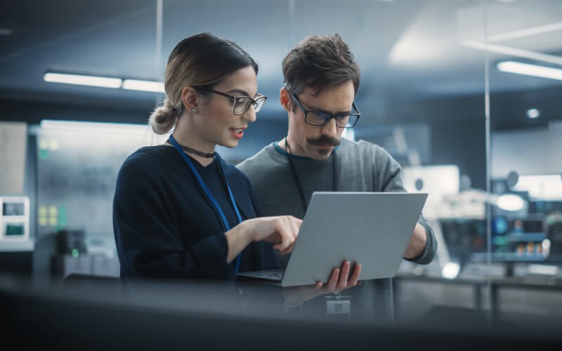 Leverage advanced threat detection. Teammates working together at the office