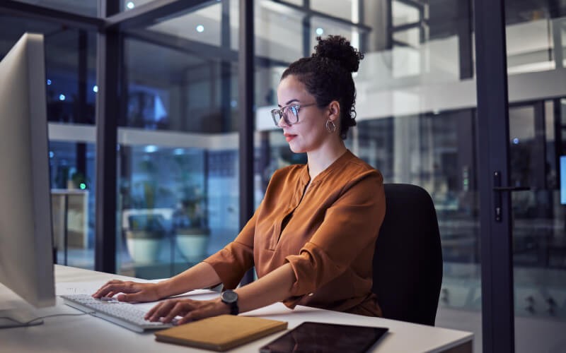 Replace your VPN with zero trust. Woman with glasses working