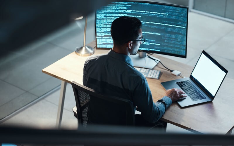 Implement a Zero trust strategy. Man coding at the office