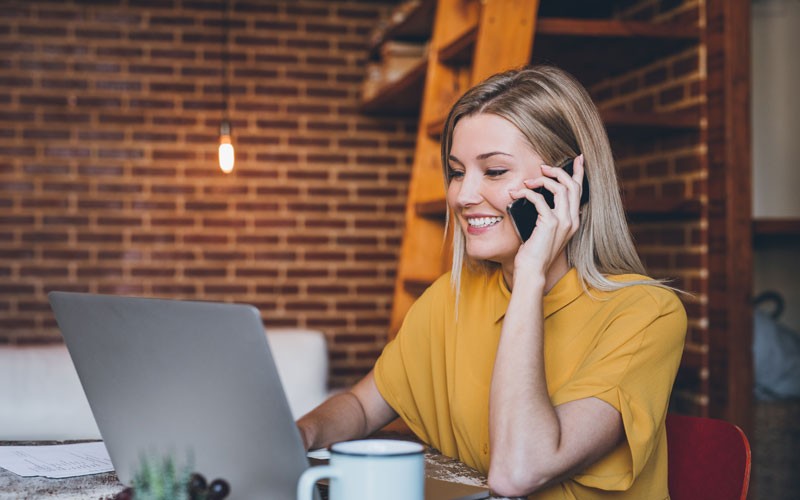 Remote desktop access Woman working on mobile phone and laptop remotely