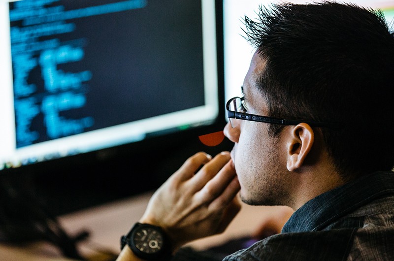 Threat protection delivery Developer working in front of laptop