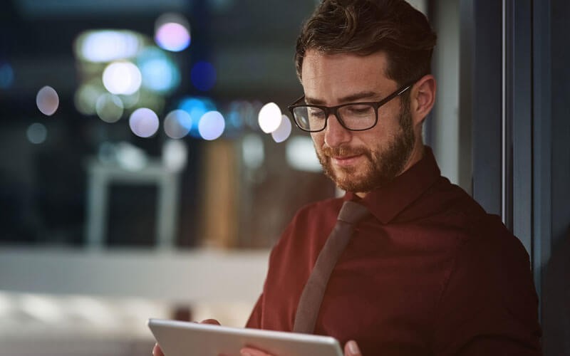 Detect analyze and respond to security threats using Trend Micro Deep Discovery Developer working on computer in office