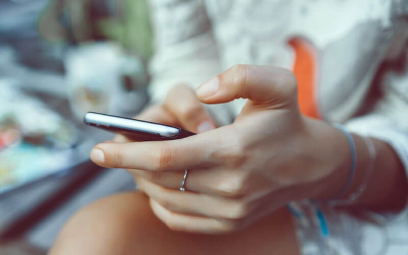 Communicate and collaborate more confidently in the cloud Woman's hands on phone screen