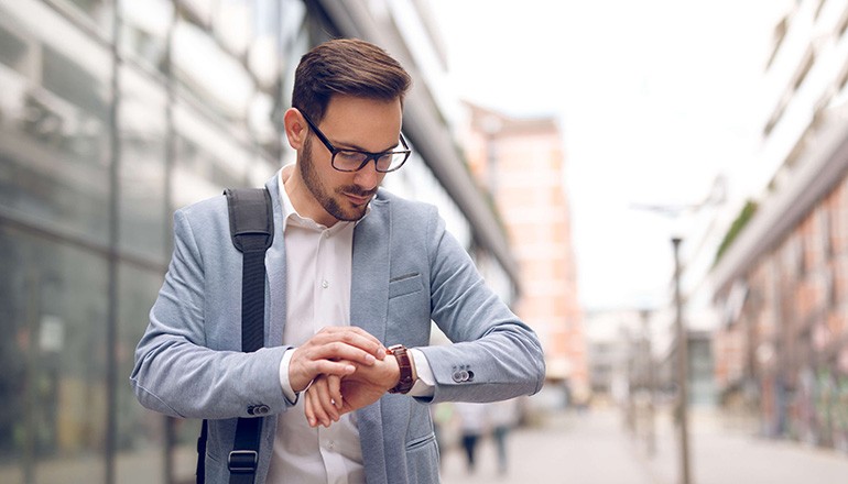 Case study: Fashion Watch Manufacturer Expands to New Line of Business Business man checking messages on his smart watch