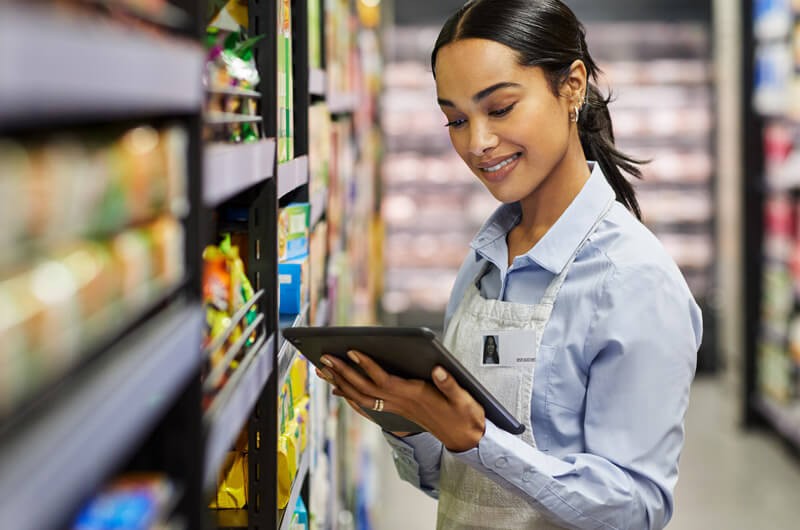 Spend more time selling and less time preparing Female employee using tablet at work in modern supermarket