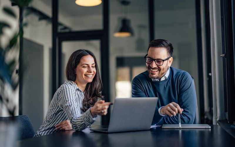 collaborating-users-smiling-in-office-meeting-room-at-laptop collaborating-users-smiling-in-office-meeting-room-at-laptop