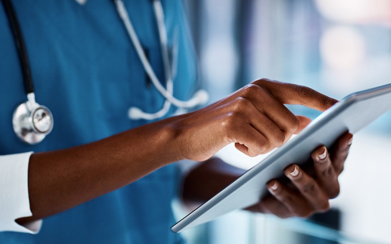 Healthcare data security solutions help keep up with patient information Close up of doctor using tablet device