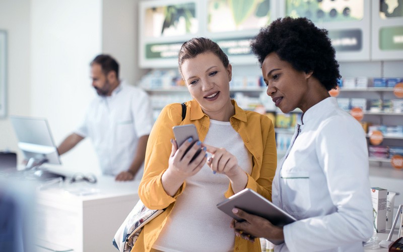 Deploy a high-performance system so you won’t experience downtime Patient with cell phone asking doctor with tablet a question