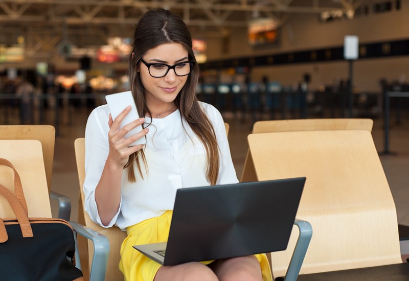 Hospitality technology that builds connections Businesswoman working from an airport travel hotspot