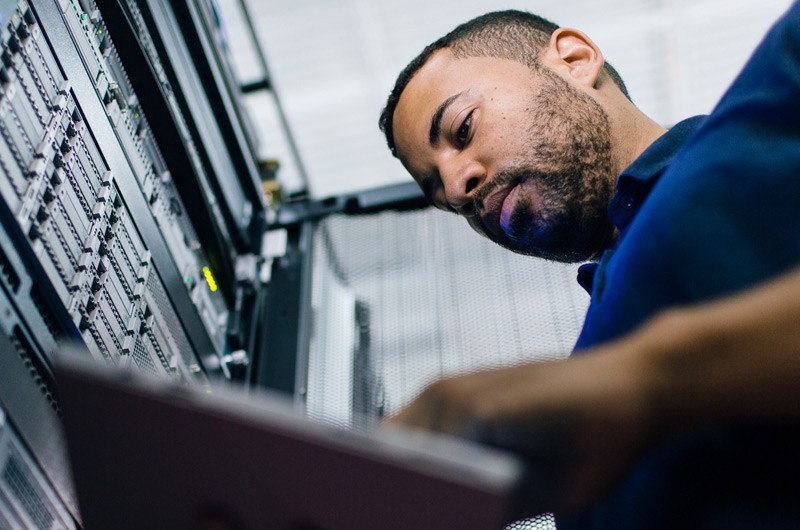 Choose products from established industry leaders Man working on a tablet in a server room