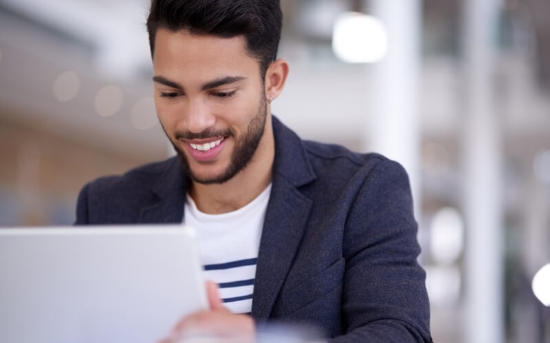 Our assessment will help you create effective data policies Smiling businessman taking assessment on laptop computer