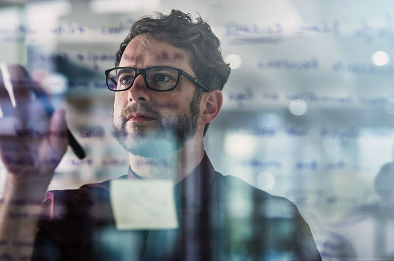 Enhances organizational flexibility and adaptability Product designer maps out product strategy on whiteboard