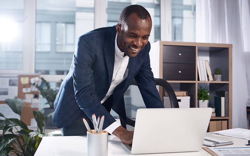 Get started easily Close up of laptop computer sitting on table with people surrounding it